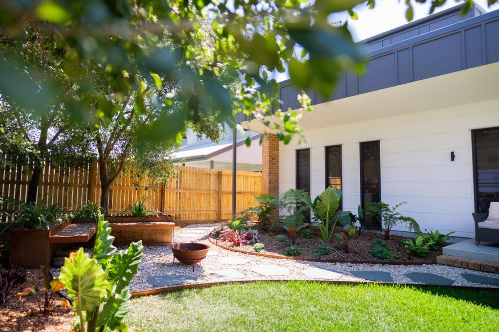 Landscaped backyard with planting, gravel and turf