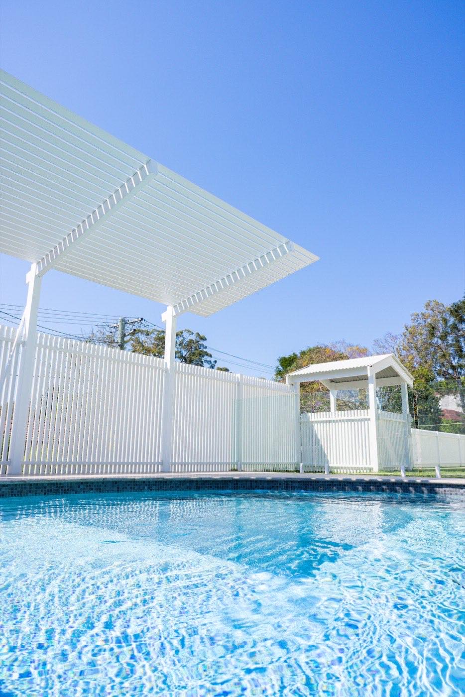 White slat pool fence with timber gate