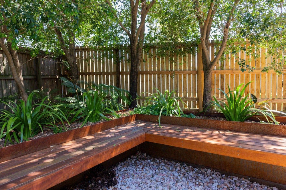 Raised timber garden beds and gravel courtyard