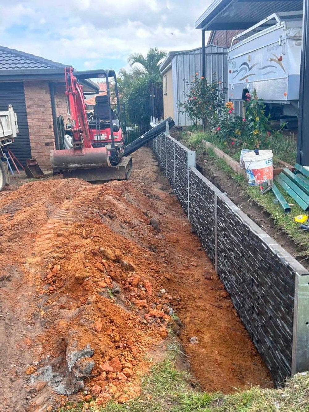 Stone-look concrete sleeper wall being installed