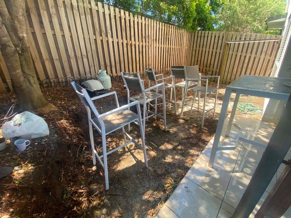 Before: bare dirt backyard corner