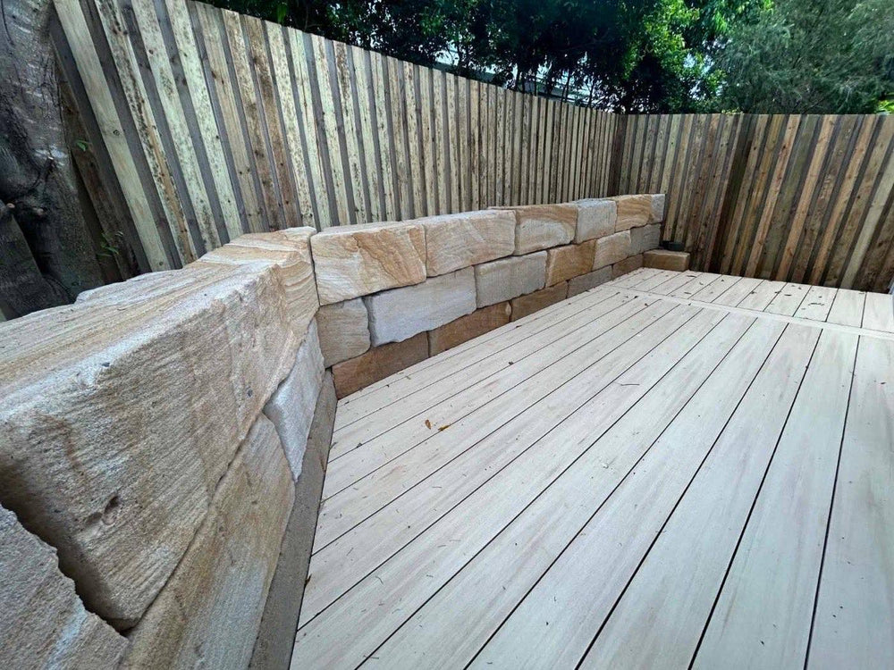 After: sandstone block retaining wall and new deck with timber fence