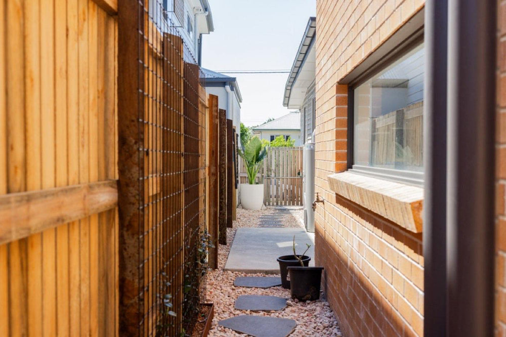 Narrow side yard with timber fence and stepping stone path
