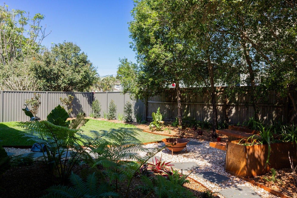 Landscaped Bayside backyard with tropical planting, turf and gravel